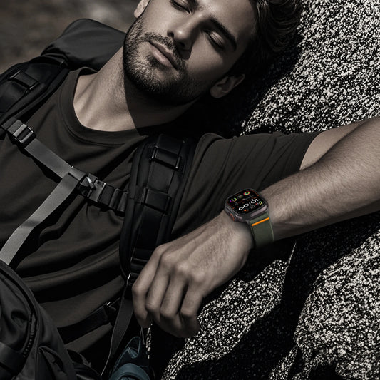 Man wearing a smartwatch outdoors with a backpack